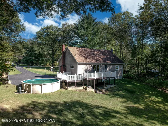 a view of a house with backyard porch and sitting area