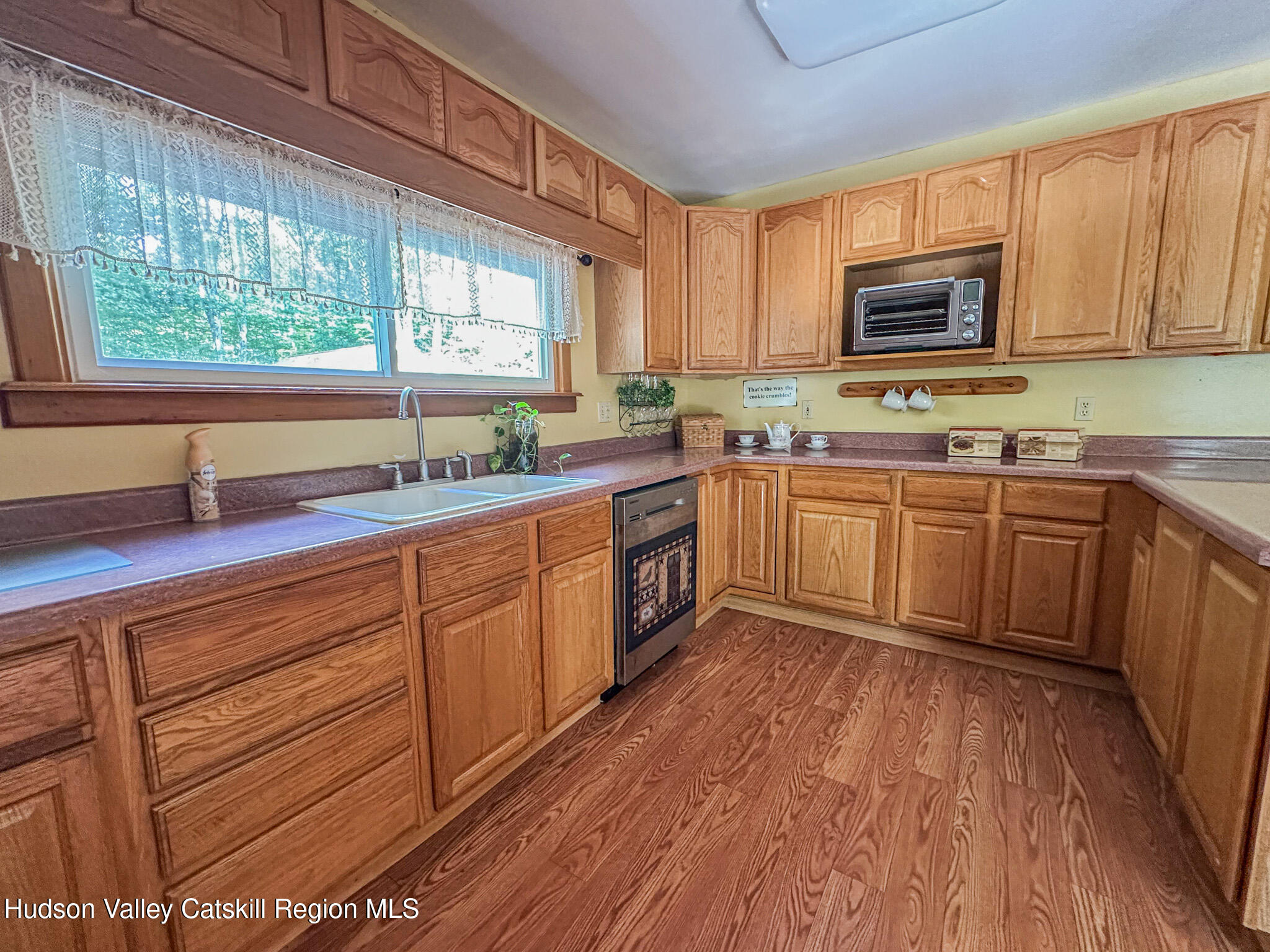 317 Scutt Road Greenville, NY 12083 - Photo 3 of 25 a kitchen with stainless steel appliances granite countertop wooden cabinets a sink and dishwasher with wooden floor