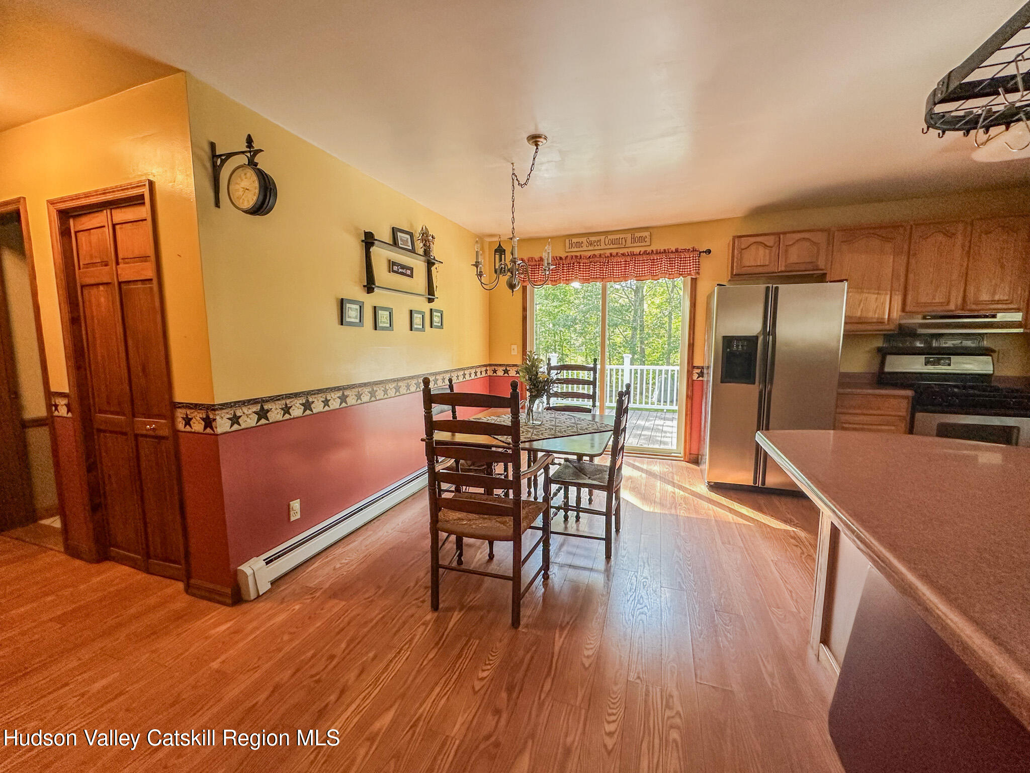 317 Scutt Road Greenville, NY 12083 - Photo 7 of 25 a dining room with furniture a chandelier and wooden floor