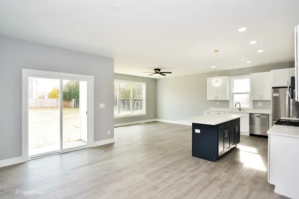 a view of kitchen with sink and refrigerator