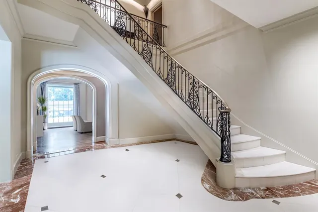 a view of a hallway with a dining table & chairs