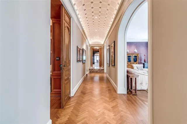 a living room with furniture a bookshelf and a window