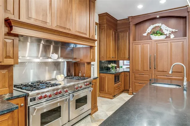 a kitchen with stainless steel appliances a stove and cabinets
