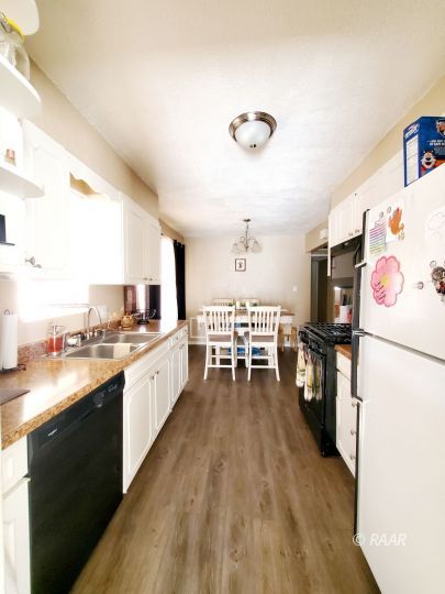 224 West Perdew Avenue Ridgecrest, CA 93555 - Photo 7 of 17 a large white kitchen with a large window