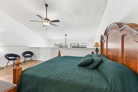 a bedroom with a bed and ceiling fan