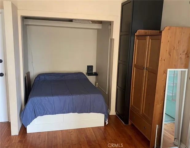 a view of bedroom with wooden floor