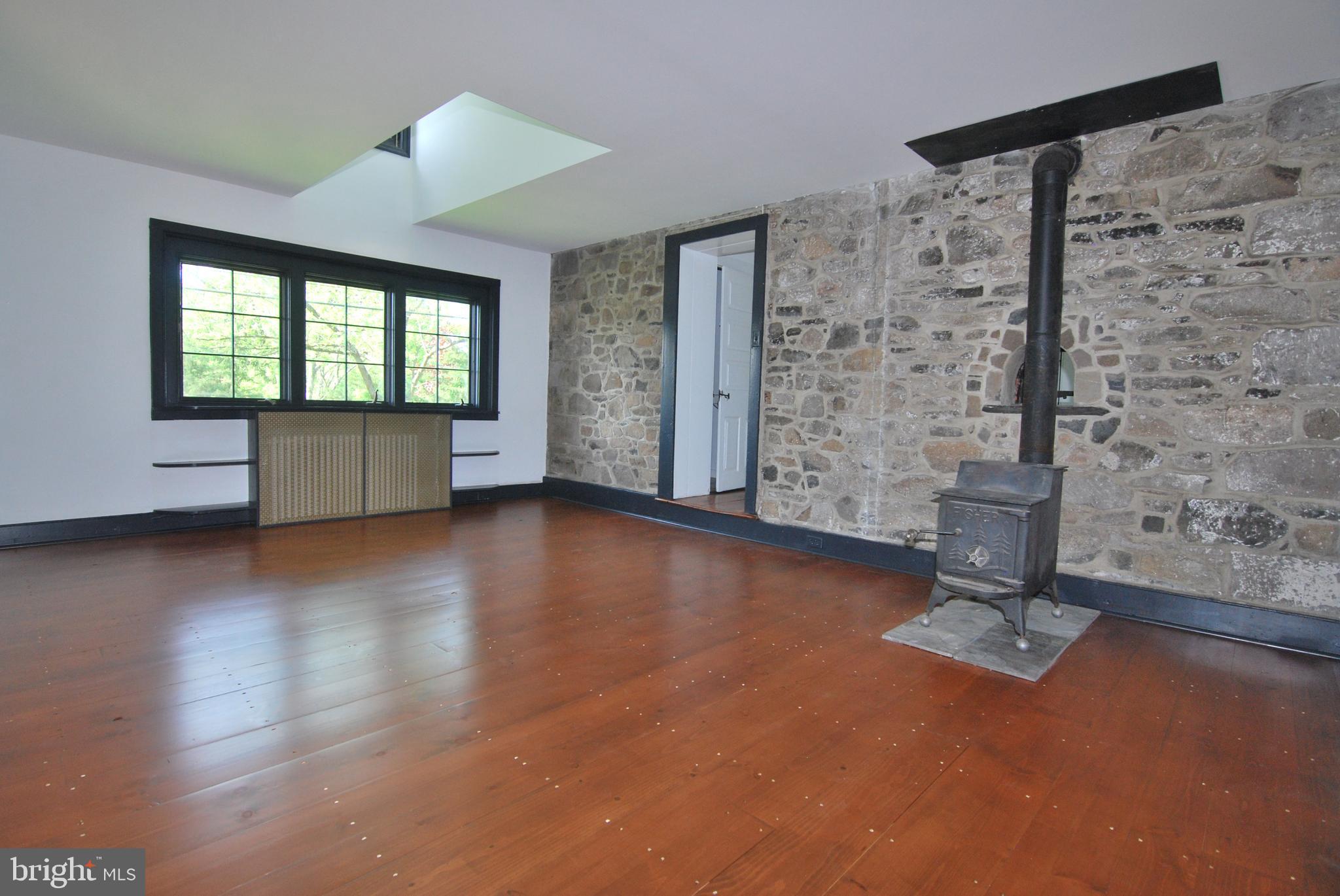 367 Pineville Road Newtown, PA 18940 - Photo 6 of 43 Exposed Stone and Wood Burning Stove in Den!