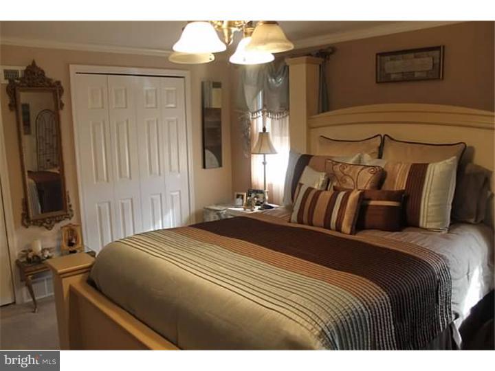 12516 Calpine Road Philadelphia, PA 19154 - Photo 10 of 22 a bedroom with a bed a mirror and a flat tv screen on dresser