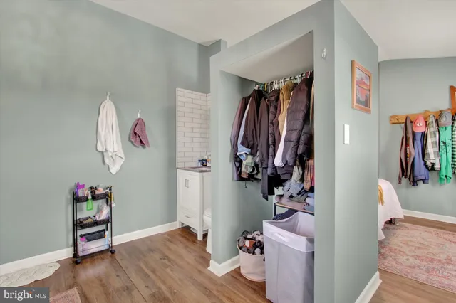 a bedroom with a bed and a painting on the wall