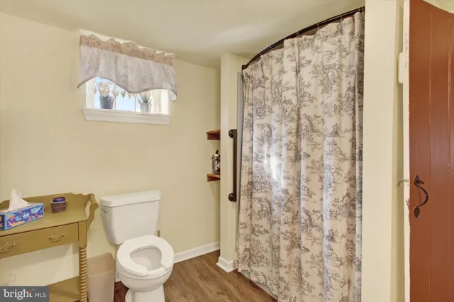 a bedroom with a bed and a chandelier next to a window