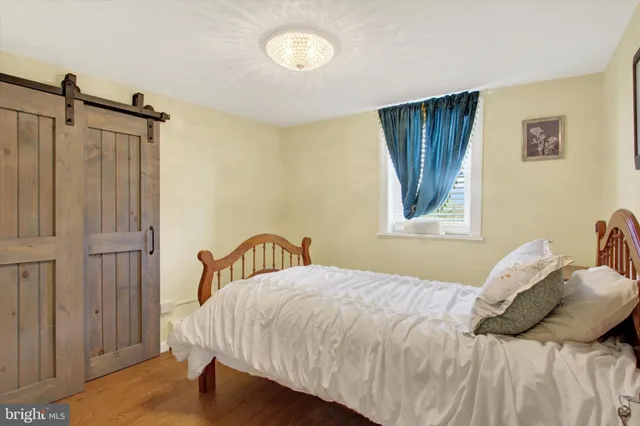 a bathroom with a toilet a sink a mirror and a window