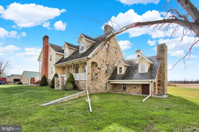an aerial view of a house with garden space and street view