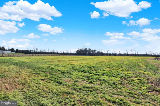 a front view of a house with a yard table and chairs