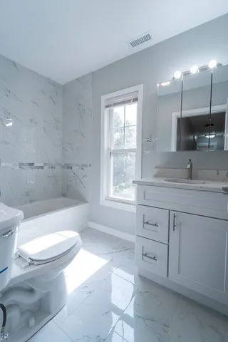 a bathroom with a sink a toilet and a bathtub