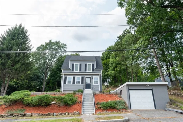 a front view of a house with a garden