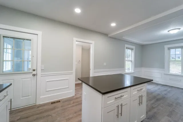 an empty room with wooden floor and window