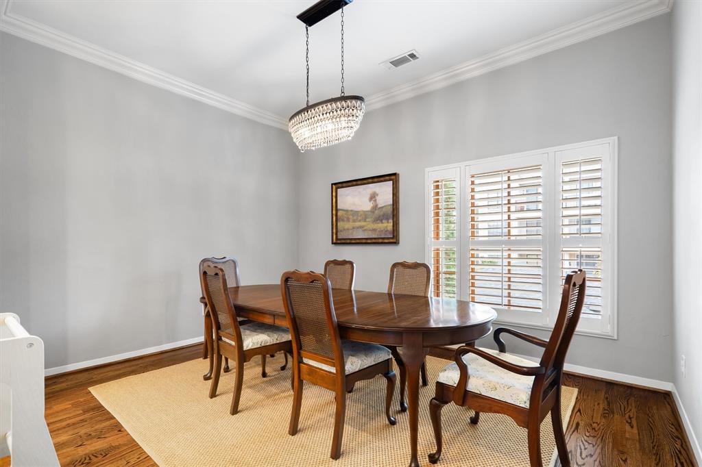 4323 Gilbert Avenue, Unit 4 Dallas, TX 75219 - Photo 23 of 40 a view of a dining room with furniture wooden floor and chandelier