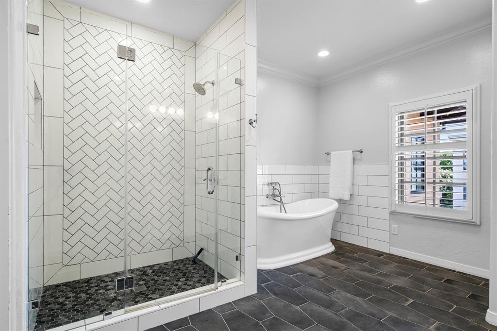 4323 Gilbert Avenue, Unit 4 Dallas, TX 75219 - Photo 35 of 40 a bathroom with a sink a toilet a window and shower