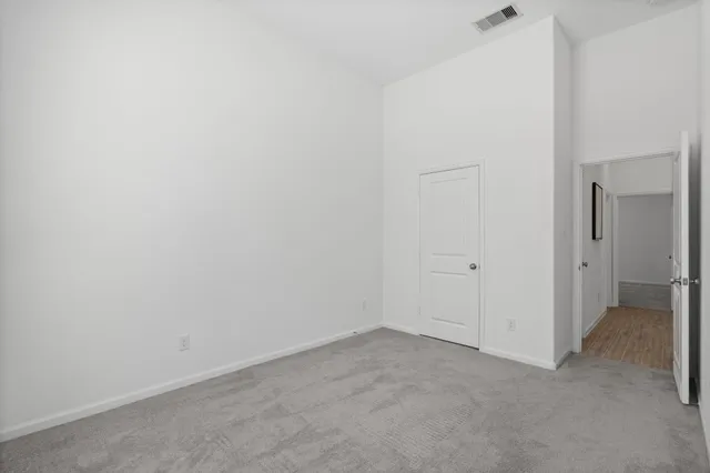 a open kitchen with stainless steel appliances granite countertop a stove top oven a refrigerator a sink dishwasher a dining table and chairs with wooden floor