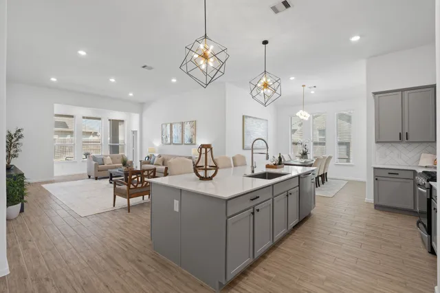 a living room with furniture wooden floor and a flat screen tv