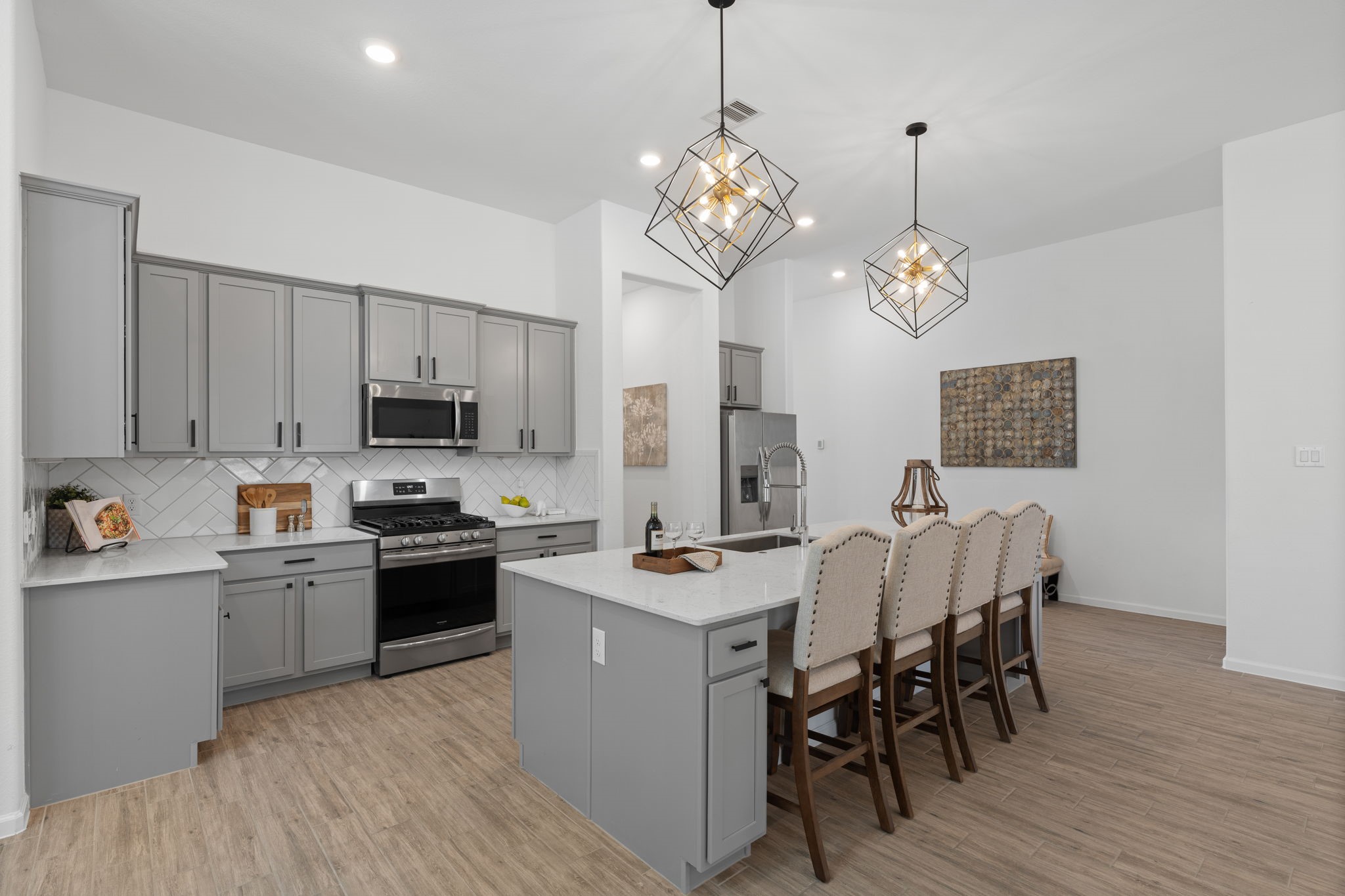 3612 Paloma Fls Lane Rosenberg, TX 77469 - Photo 20 of 49 a open kitchen with stainless steel appliances granite countertop a stove top oven a refrigerator a sink dishwasher a dining table and chairs with wooden floor