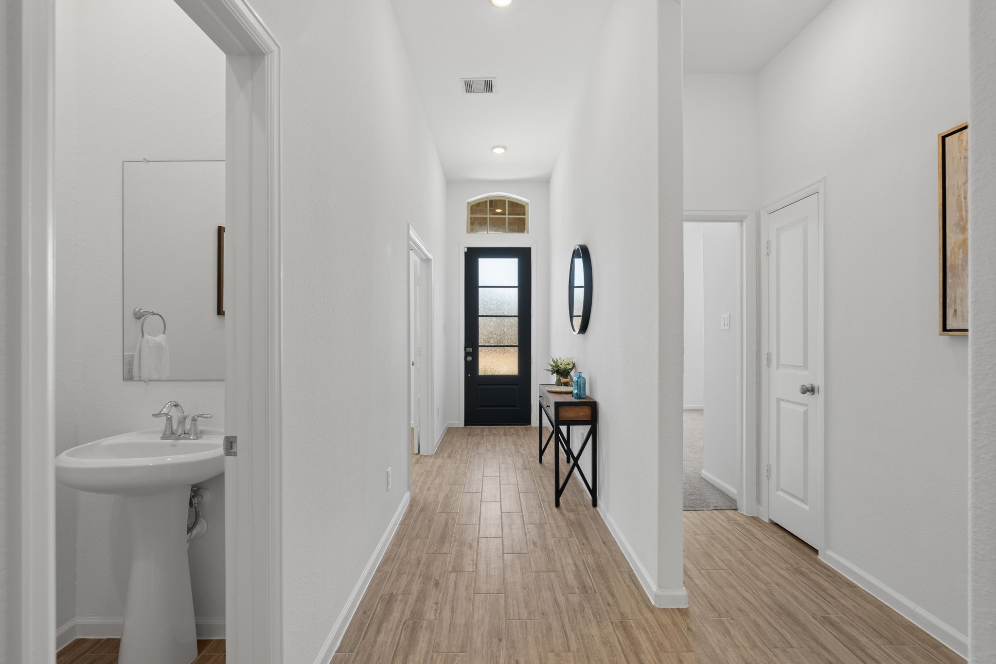 3612 Paloma Fls Lane Rosenberg, TX 77469 - Photo 7 of 49 a view of a hallway with wooden floor and a bathroom