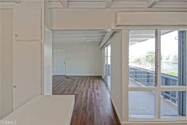 a view of a room with wooden floor and windows