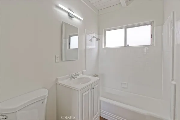a bathroom with a sink a toilet and bathtub