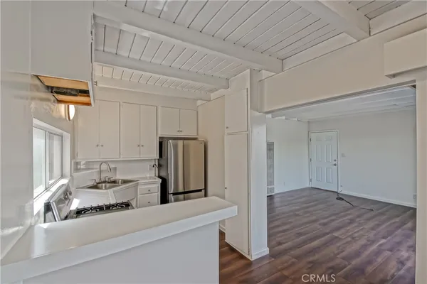 a kitchen with a refrigerator and a sink