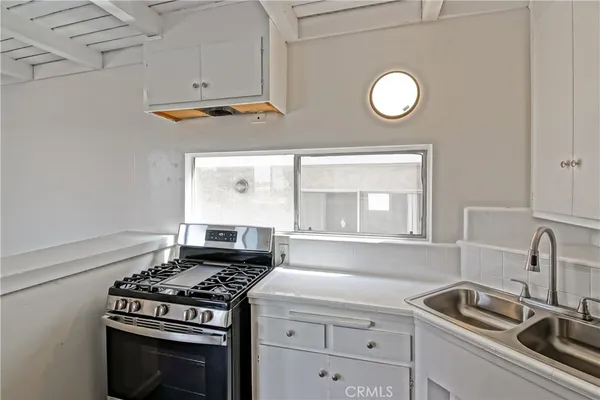 a kitchen with cabinets appliances and a sink