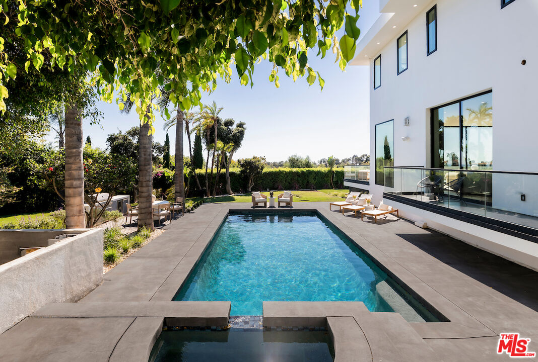 5931 Kanan Dume Road Malibu, CA 90265 - Photo 12 of 53 a swimming pool with outdoor seating and yard