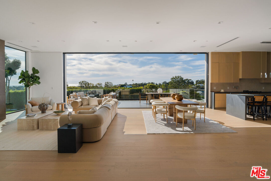 5931 Kanan Dume Road Malibu, CA 90265 - Photo 16 of 53 a living room with furniture and a floor to ceiling window