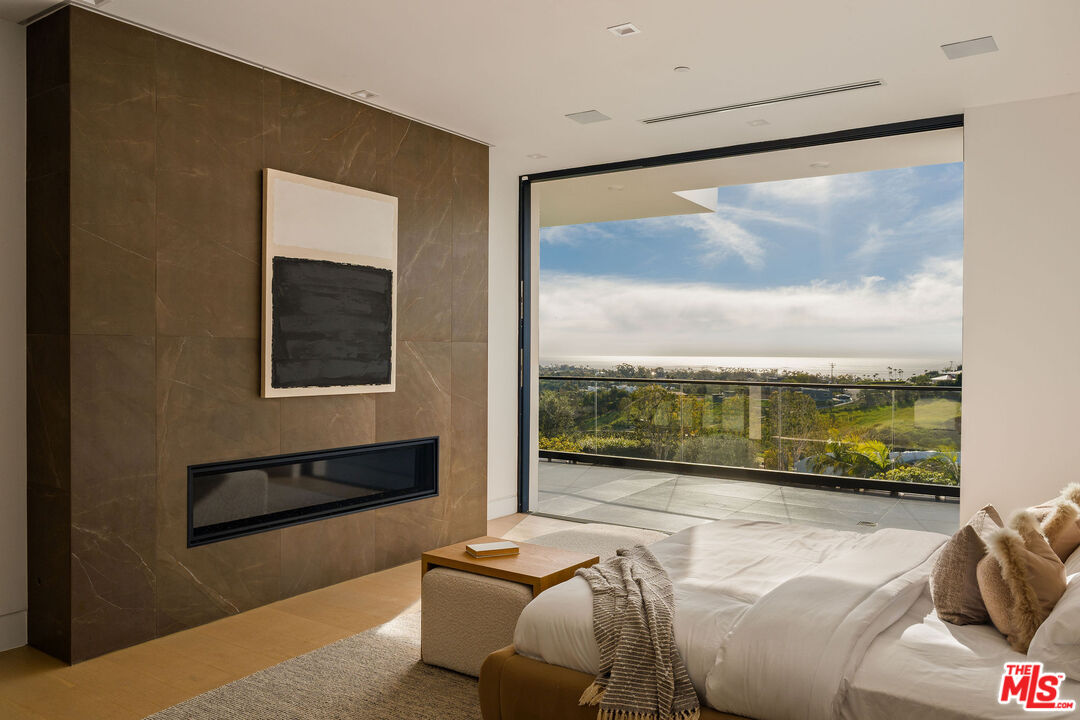 5931 Kanan Dume Road Malibu, CA 90265 - Photo 28 of 53 a living room with furniture large window and a flat screen tv