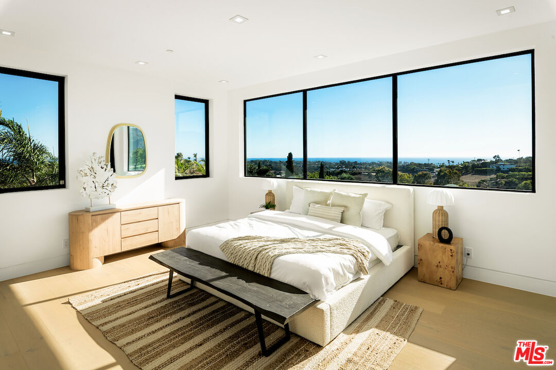 5931 Kanan Dume Road Malibu, CA 90265 - Photo 40 of 53 a bedroom with a bed and large window