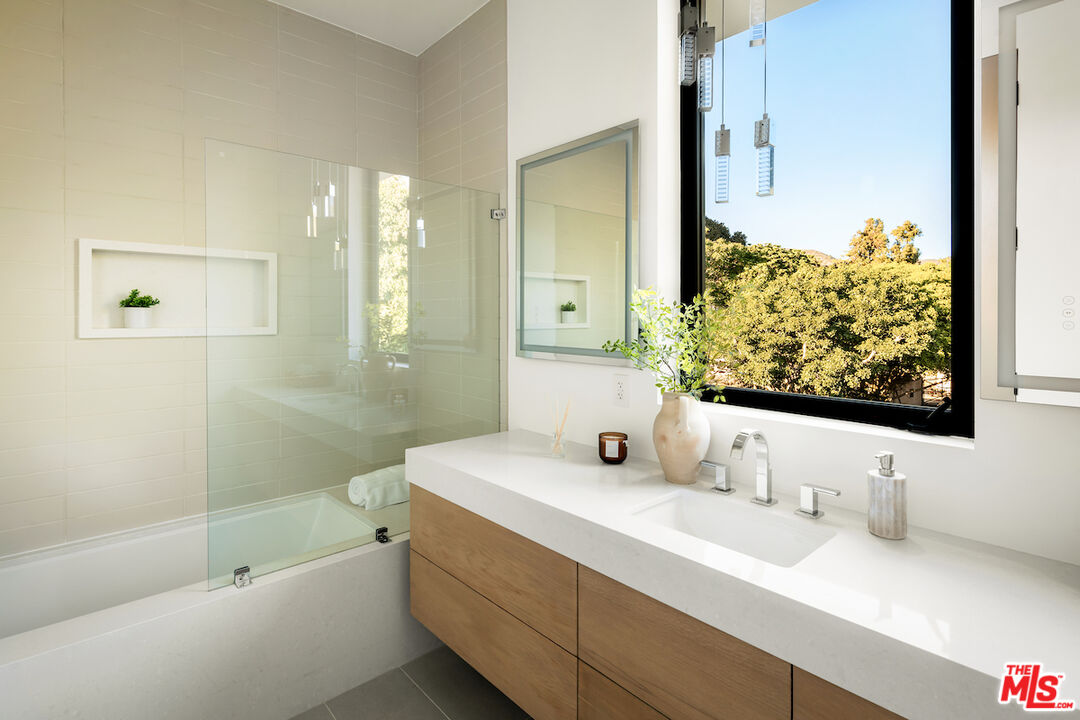 5931 Kanan Dume Road Malibu, CA 90265 - Photo 41 of 53 a bathroom with a tub sink and mirror