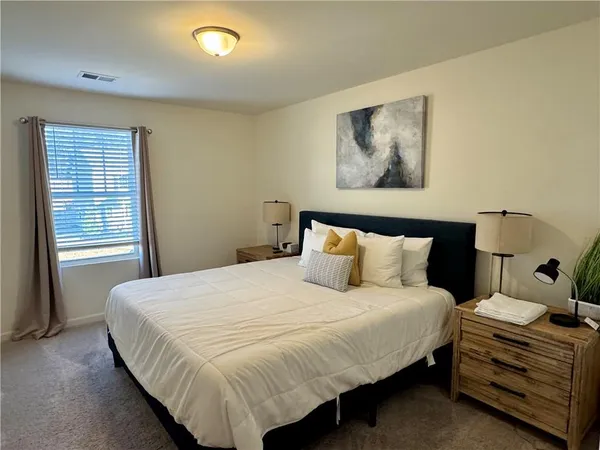 a bedroom with a bed and a window