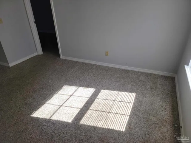 an empty room with a floor to ceiling window