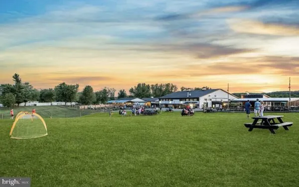 a swimming pool with outdoor seating and yard