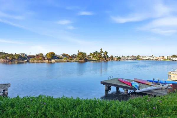a view of a lake with houses in the back