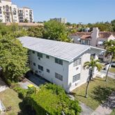 an aerial view of a house with a yard and balcony