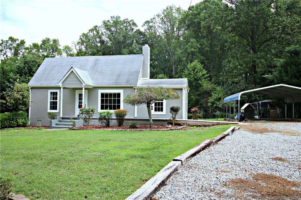 1130 Shue Road China Grove, NC 28023 - Photo 1 of 21 a front view of a house with a garden and trees