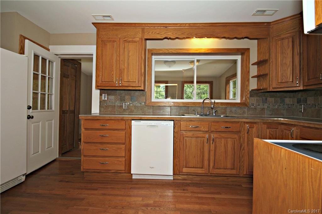 1130 Shue Road China Grove, NC 28023 - Photo 6 of 21 a kitchen with granite countertop wooden cabinets and a sink
