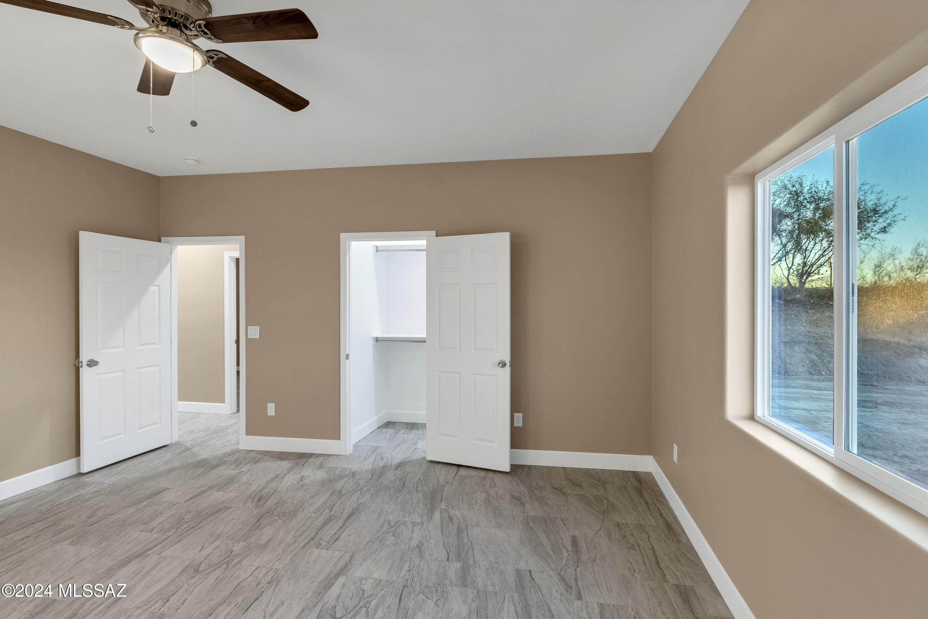221 Paseo Mascota Rio Rico, AZ 85648 - Photo 25 of 45 wooden floor in an empty room with a window
