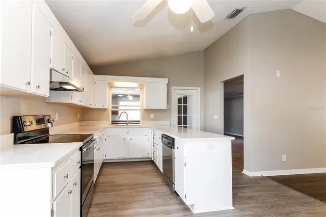 a kitchen with stainless steel appliances granite countertop a stove oven and a refrigerator