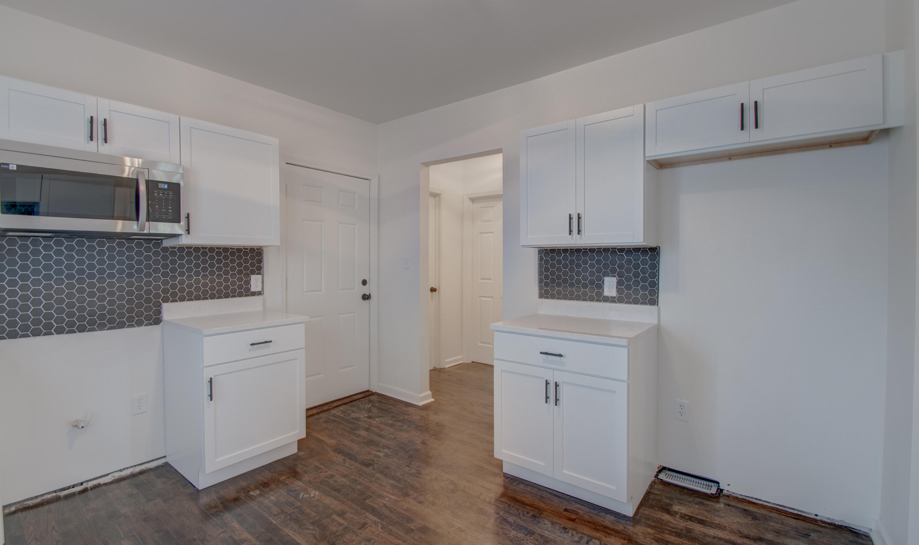 613 Tennessee Street Gary, IN 46402 - Photo 24 of 39 a kitchen with white cabinets and stainless steel appliances