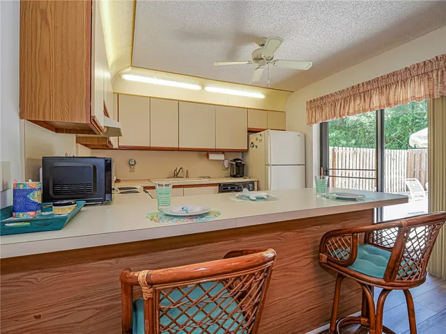a kitchen with furniture a large window and a sink