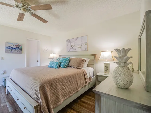 a bedroom with a bed and ceiling fan