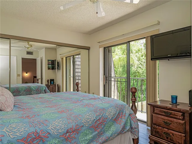 a bedroom with a bed and flat screen tv