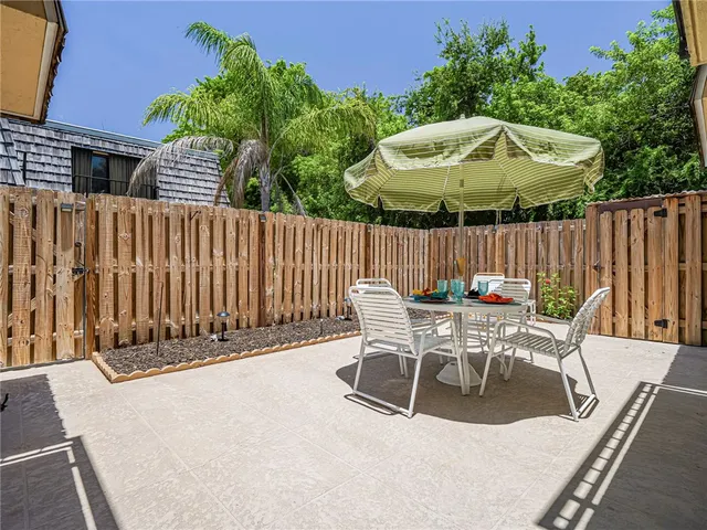 a view of backyard with swimming pool and furniture