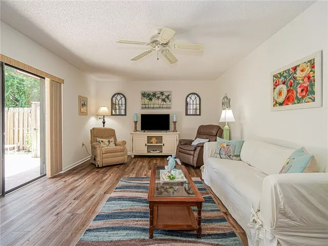 a living room with furniture a rug and a flat screen tv